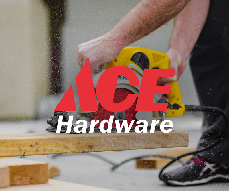 man using saw on wood plank with ace hardware logo on top of image